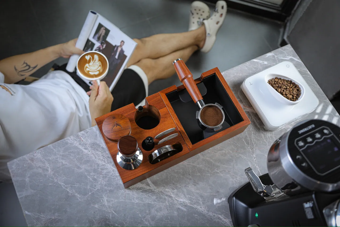 A rosewood tamping station with tamper and tools, seen from above