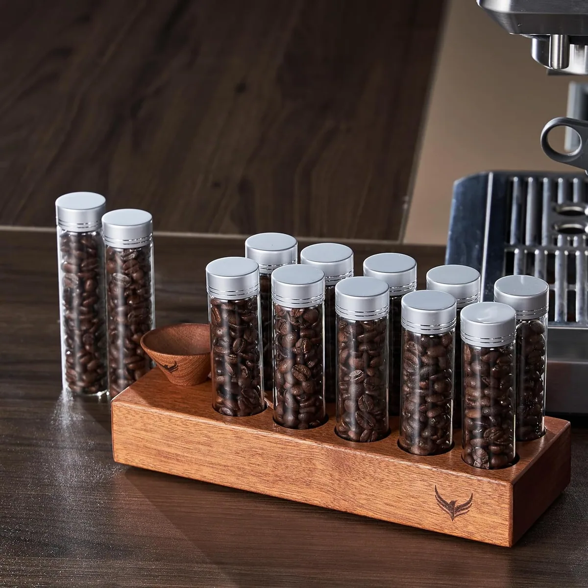 Glass single dose tubes of coffee beans standing in a walnut rack