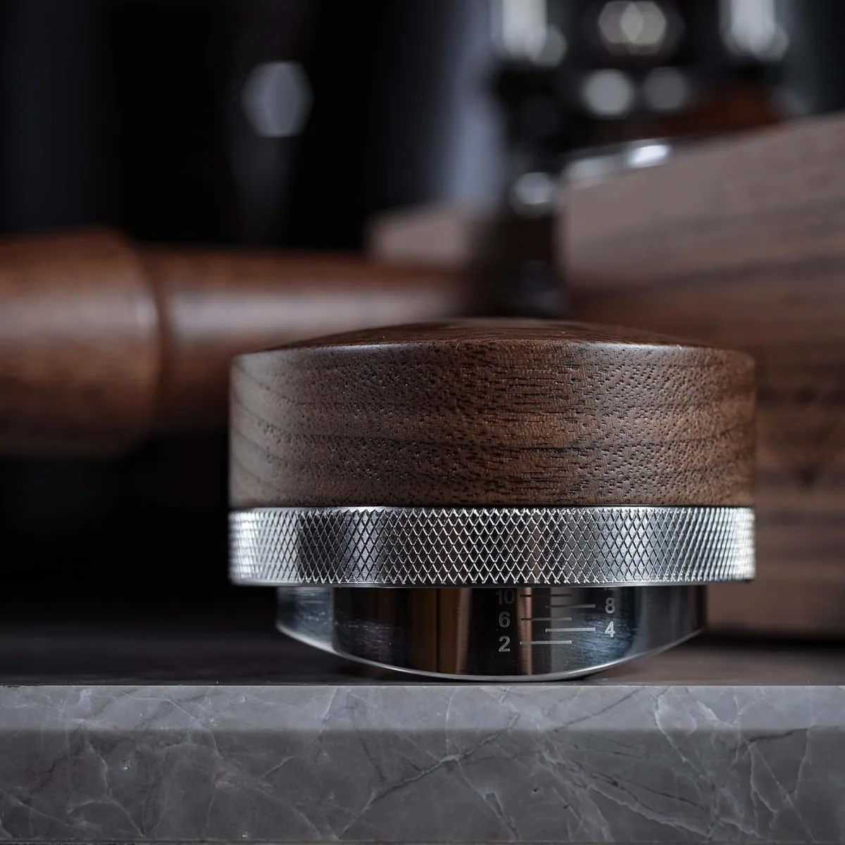 Close view of a walnut distributor with a knurled steel collar