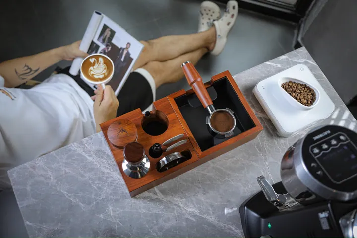 Rosewood tamping station, tamper and dosing tools on a marble bench